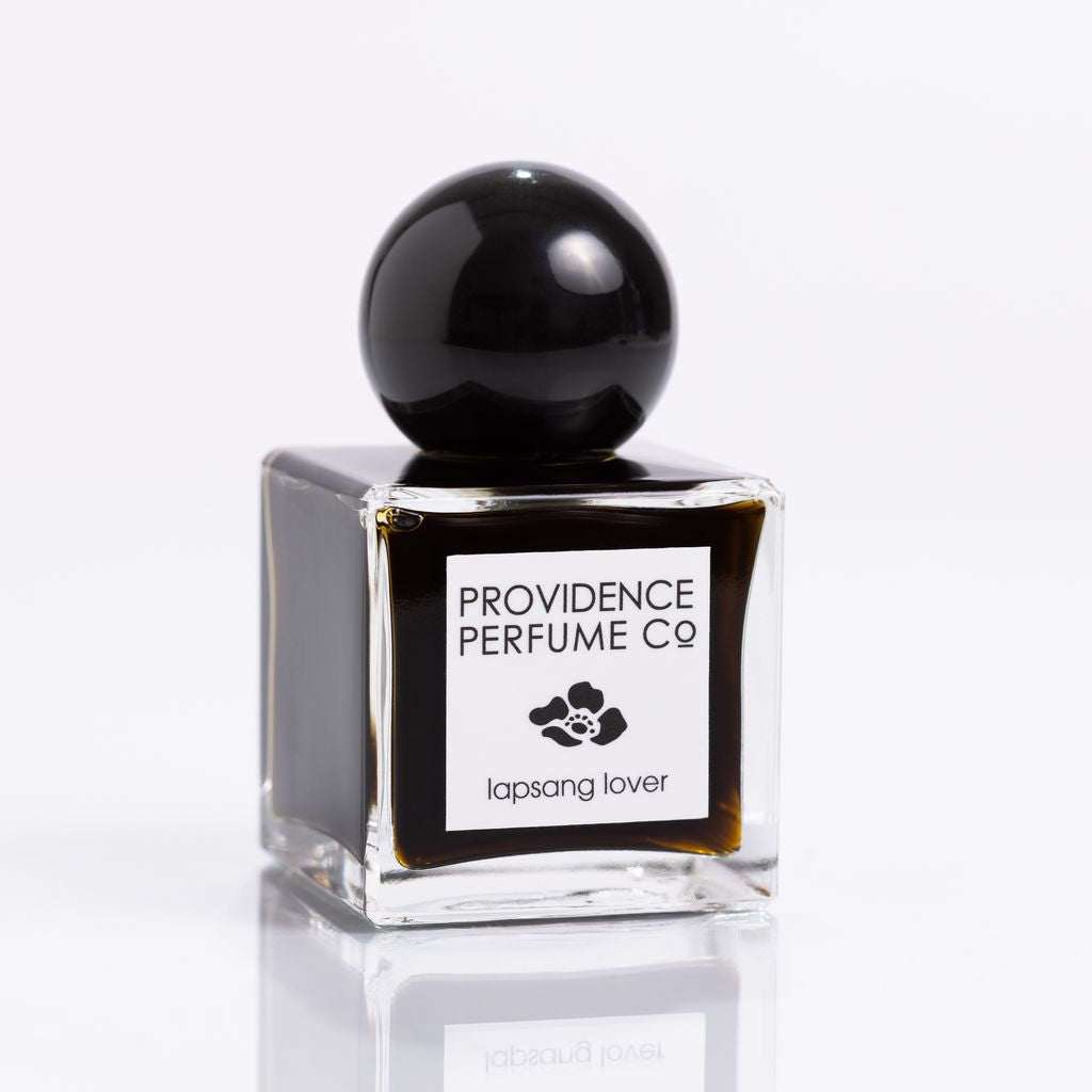 Perfume bottle with black cap and clear base on a white background, featuring 'Providence Perfume Co' label.