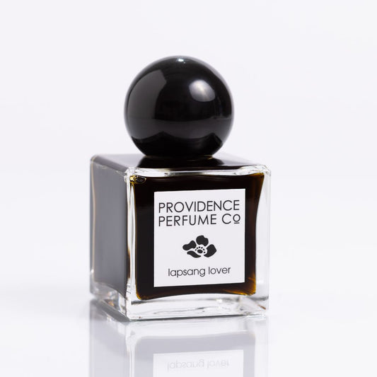 Perfume bottle with black cap and clear base on a white background, featuring 'Providence Perfume Co' label.