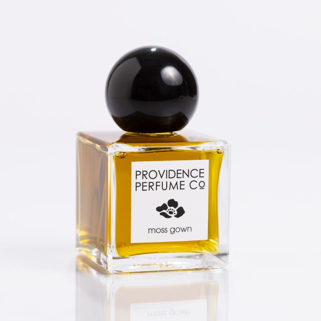 Perfume bottle with black cap and 'Providence Perfume Co' label on a white background