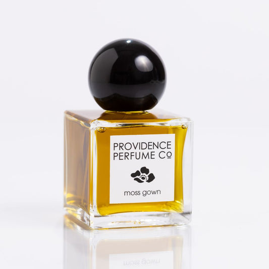 Perfume bottle with black cap and 'Providence Perfume Co' label on a white background