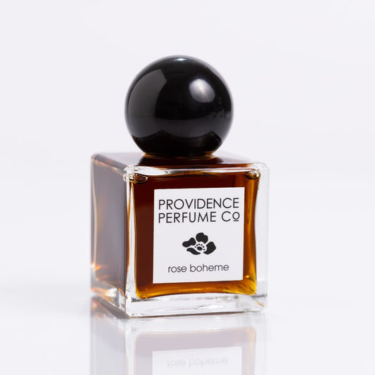 Perfume bottle with black cap and 'Providence Perfume Co' label on a white background