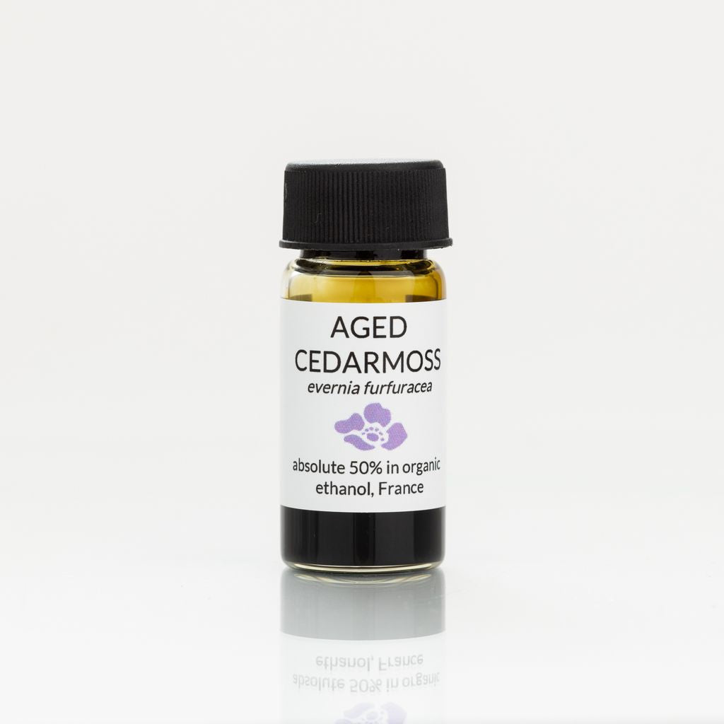 Bottle of Aged Cedarmoss absolute with a black cap on a white background