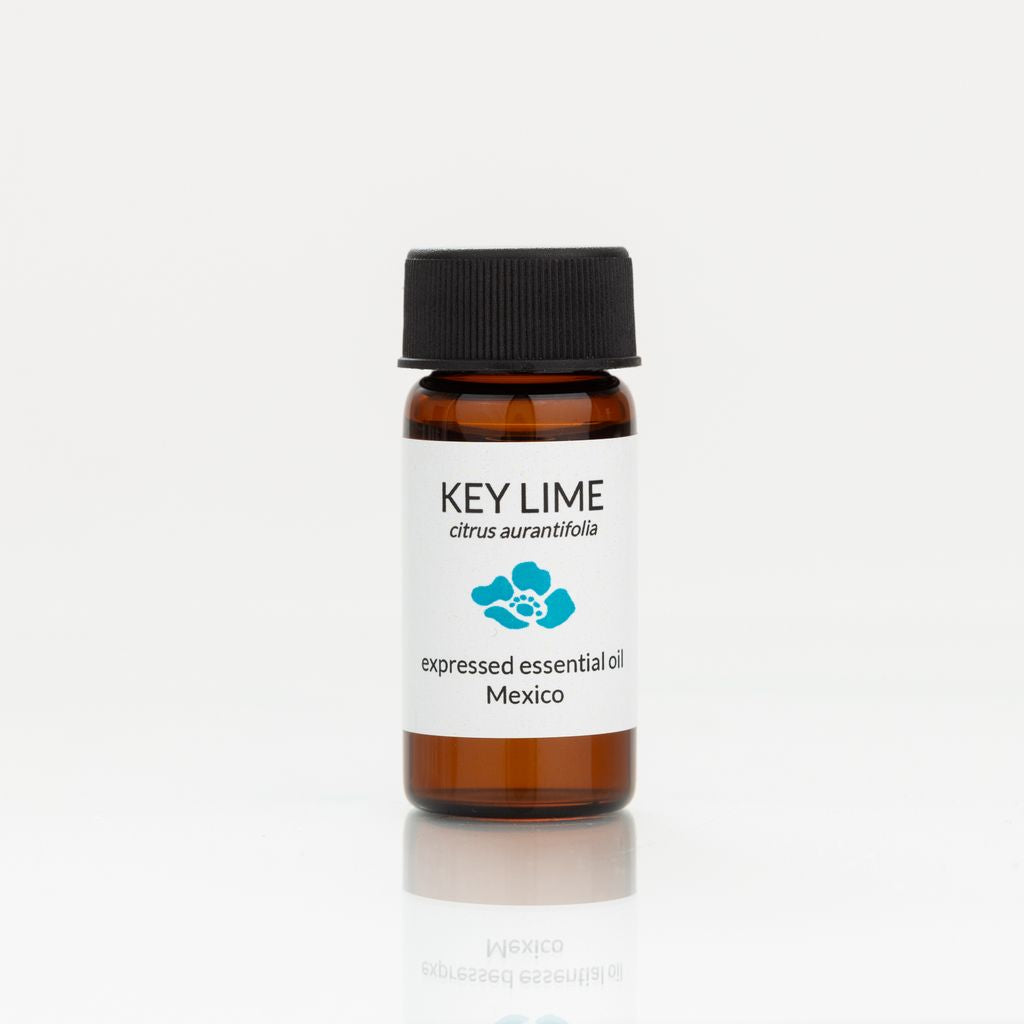 Key lime essential oil bottle with a black cap on a white background